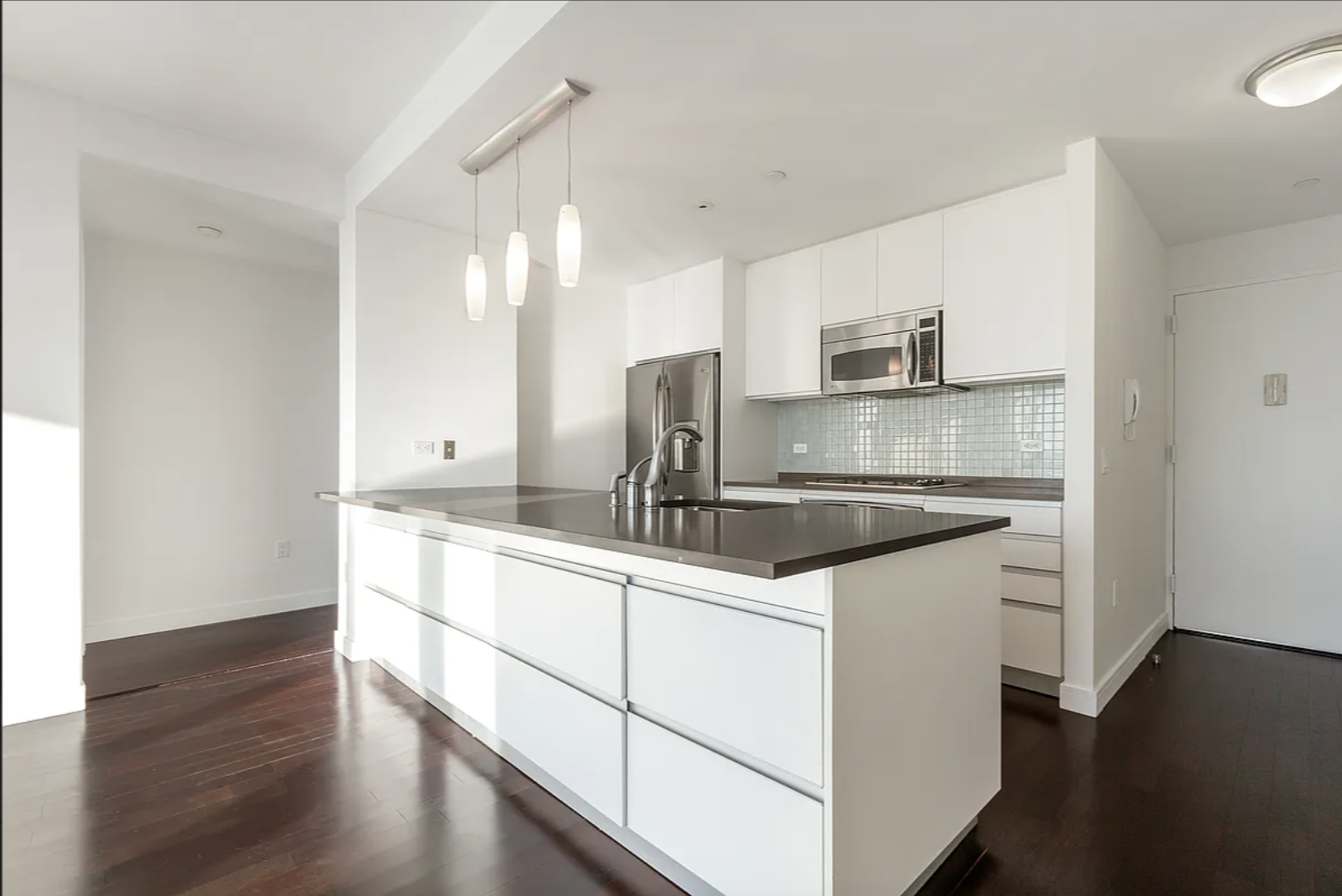 306 Gold Street, Unit 37E Brooklyn, NY 11201 - Photo 2 of 12 a kitchen with stainless steel appliances granite countertop a sink stove and microwave