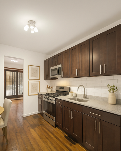 560 Macon Street, Unit 1 Brooklyn, NY 11233 - Photo 2 of 6 a kitchen with stainless steel appliances granite countertop a sink stove and cabinets