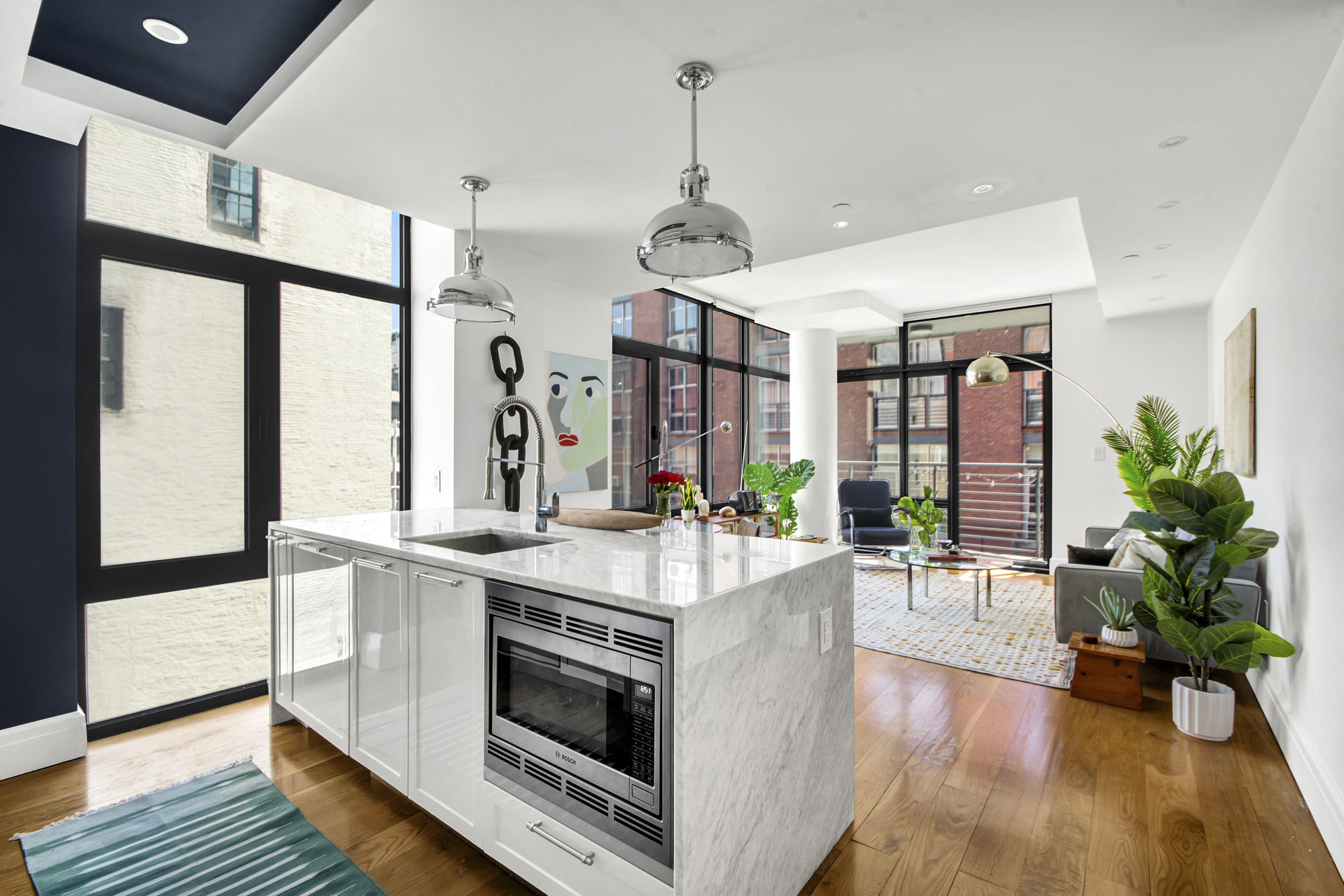 47 Bridge Street, Unit 3DD Brooklyn, NY 11201 - Photo 4 of 24 a view of living room with kitchen island stainless steel appliances furniture stove and wooden floor