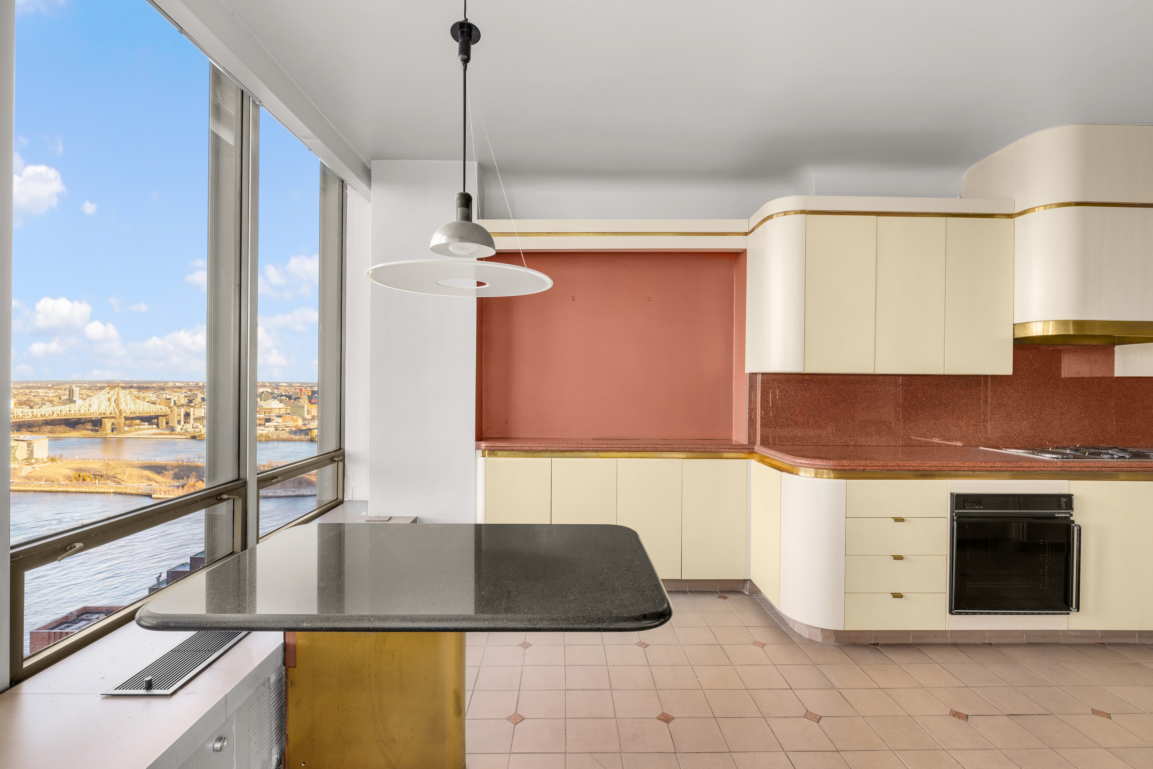 860 United Nations Plaza, Unit 36D Manhattan, NY 10017 - Photo 14 of 21 a kitchen with stainless steel appliances granite countertop a stove a sink and a microwave