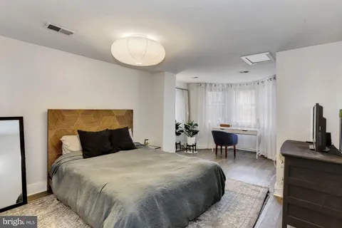 a bedroom with a bed and chair