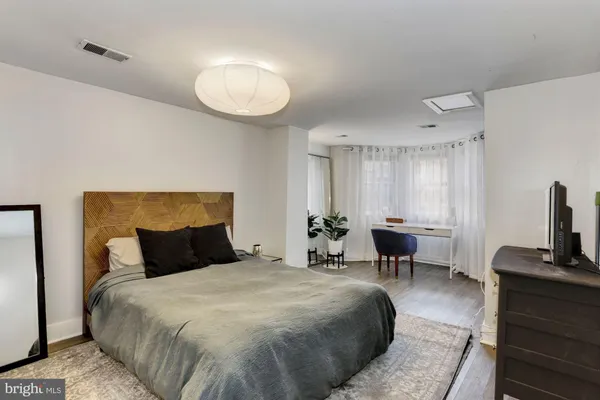 a bedroom with a bed and chair