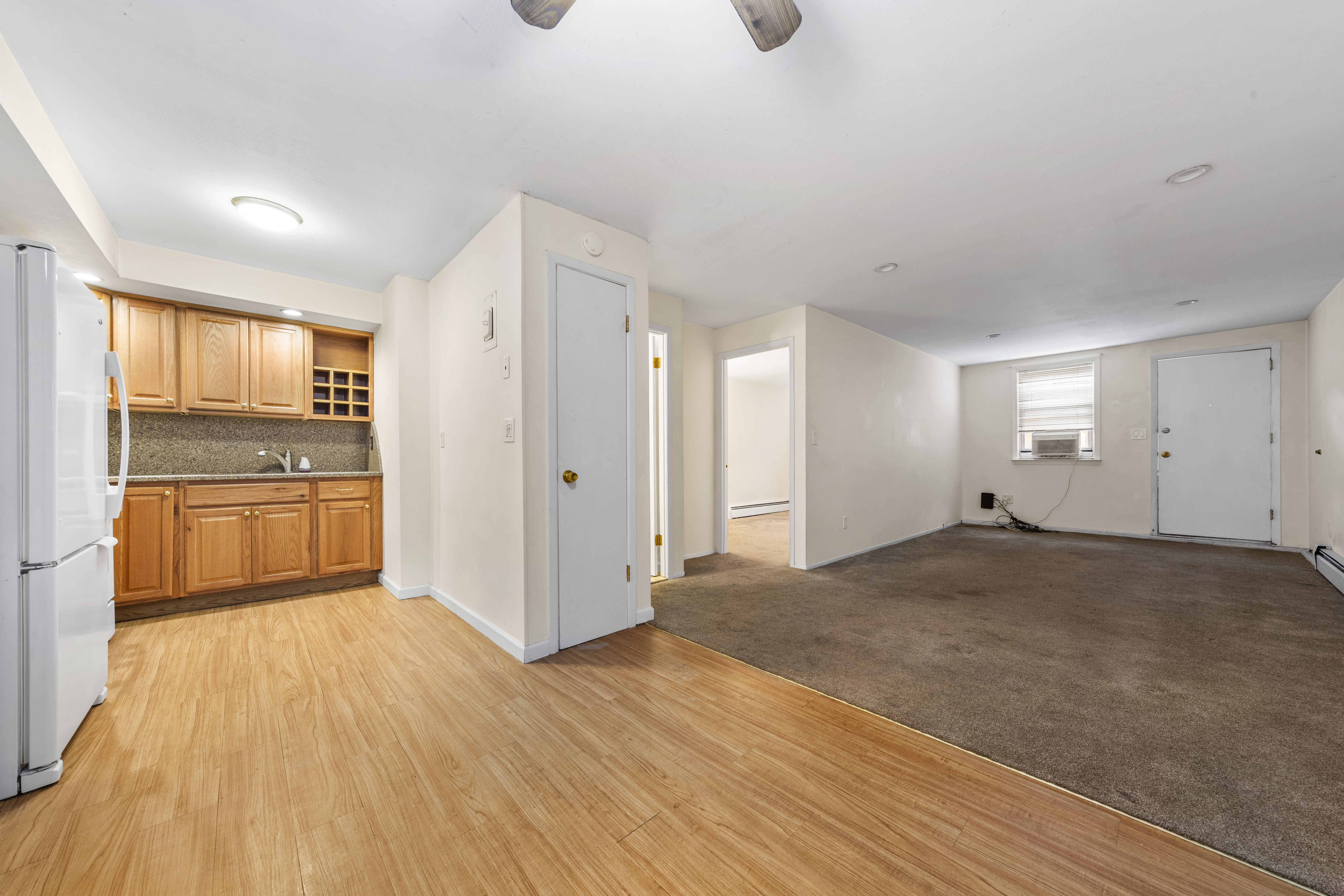 240-47 68th Avenue Queens, NY 11362 - Photo 22 of 39 a view of a kitchen with a sink and a refrigerator
