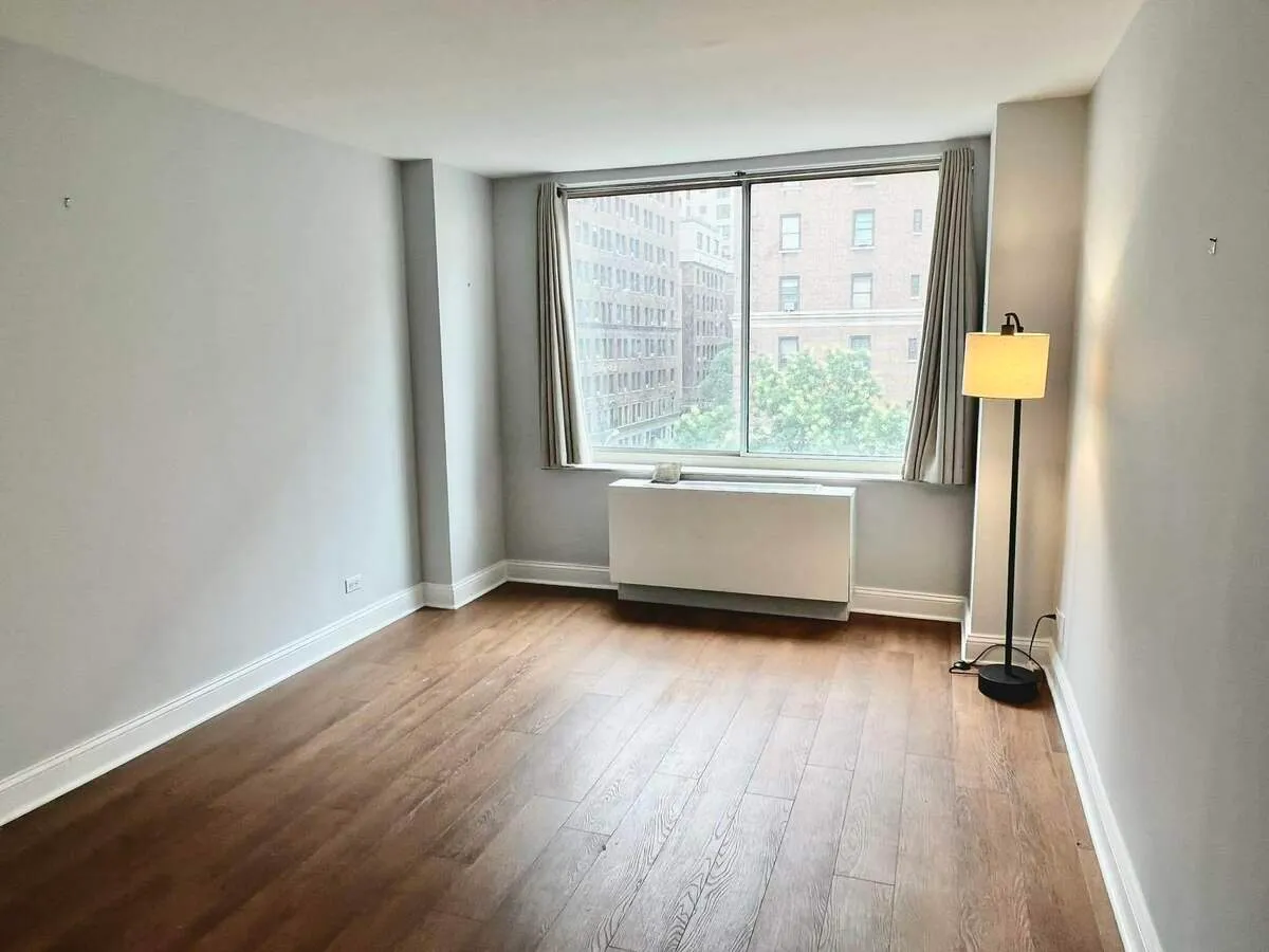 250 West 90th Street, Unit 6I Manhattan, NY 10024 - Photo 4 of 15 an empty room with wooden floor and windows