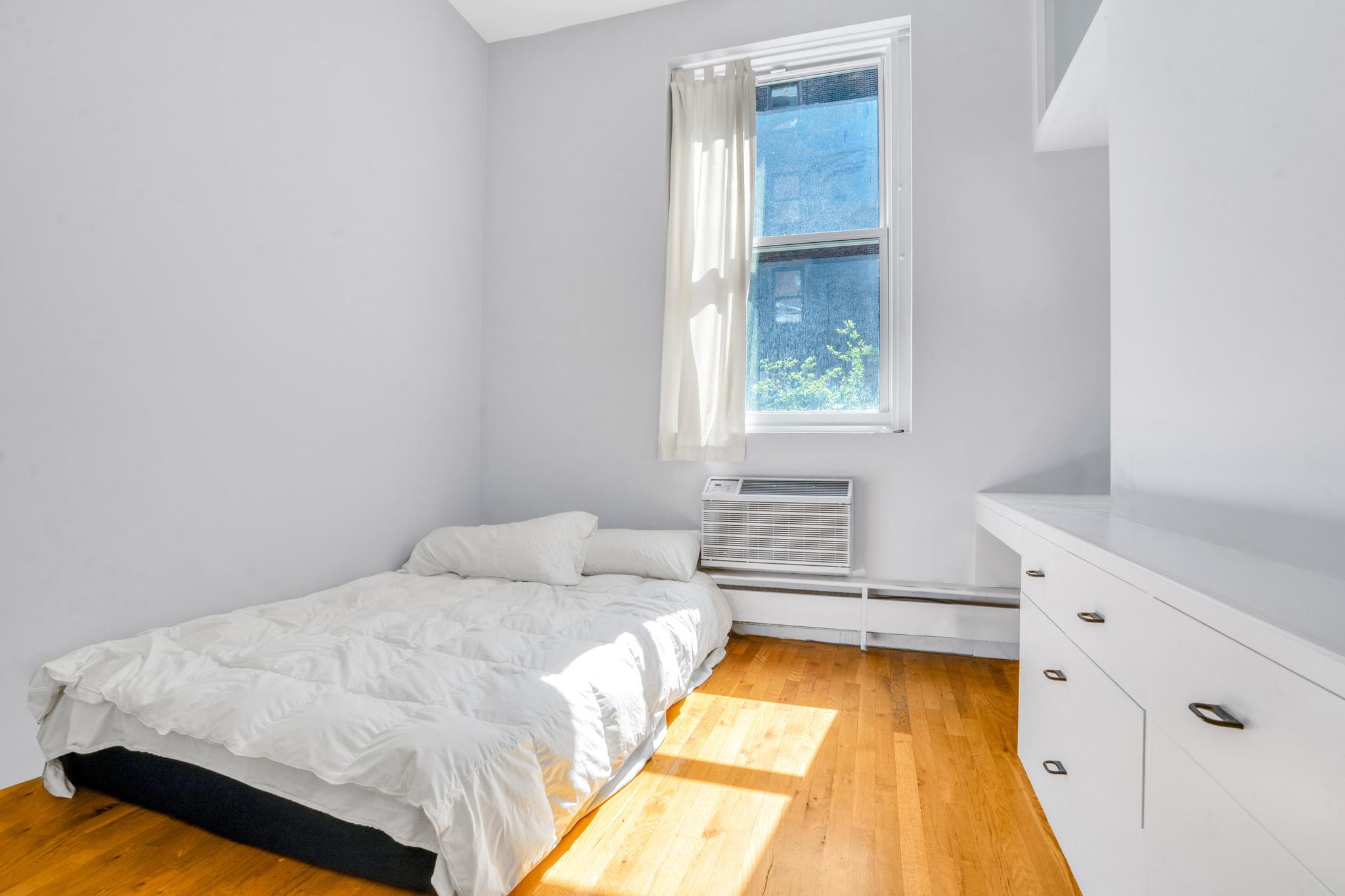 363 Greenwich Street, Unit 3C Manhattan, NY 10013 - Photo 10 of 11 a bedroom with a bed and a window
