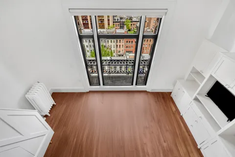 a view of an entryway with wooden floor