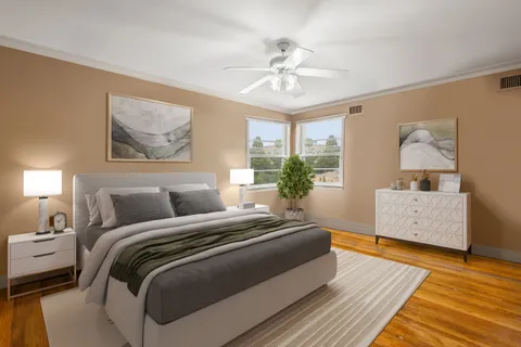 a spacious bedroom with a bed and a dresser