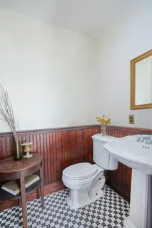 a bathroom with a toilet a sink and a mirror