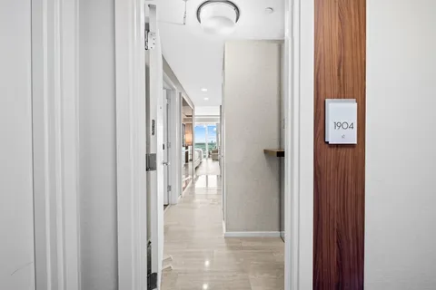 a kitchen with stainless steel appliances granite countertop a sink and a refrigerator