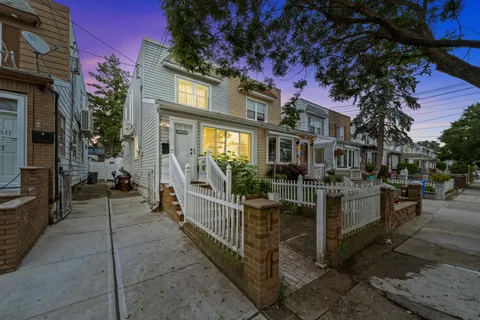 a view of a brick house with many windows