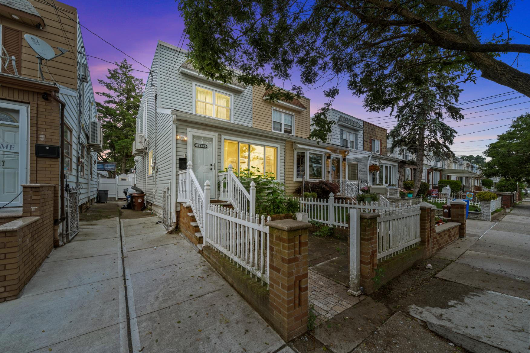 1419 East 54th Street Brooklyn, NY 11234 - Photo 1 of 19 a view of a brick house with many windows