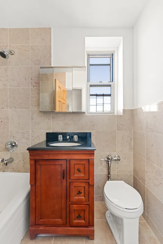 a bathroom with a sink a toilet and bathtub