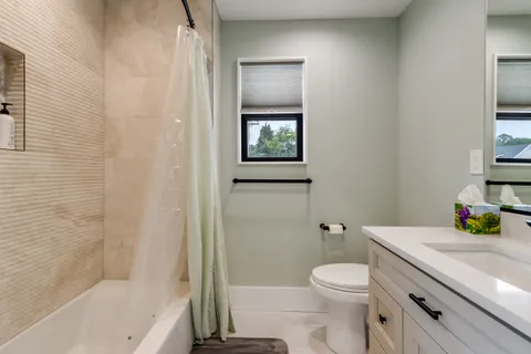 a large bed sitting in a bedroom and a table