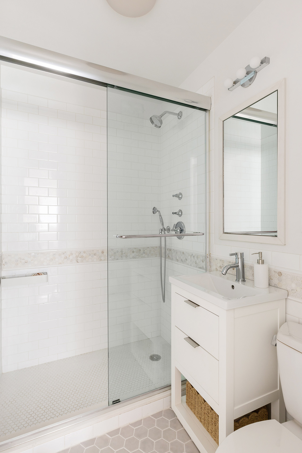 101 West 12th Street, Unit 8RS Manhattan, NY 10011 - Photo 15 of 19 a bathroom with a double vanity sink mirror and shower