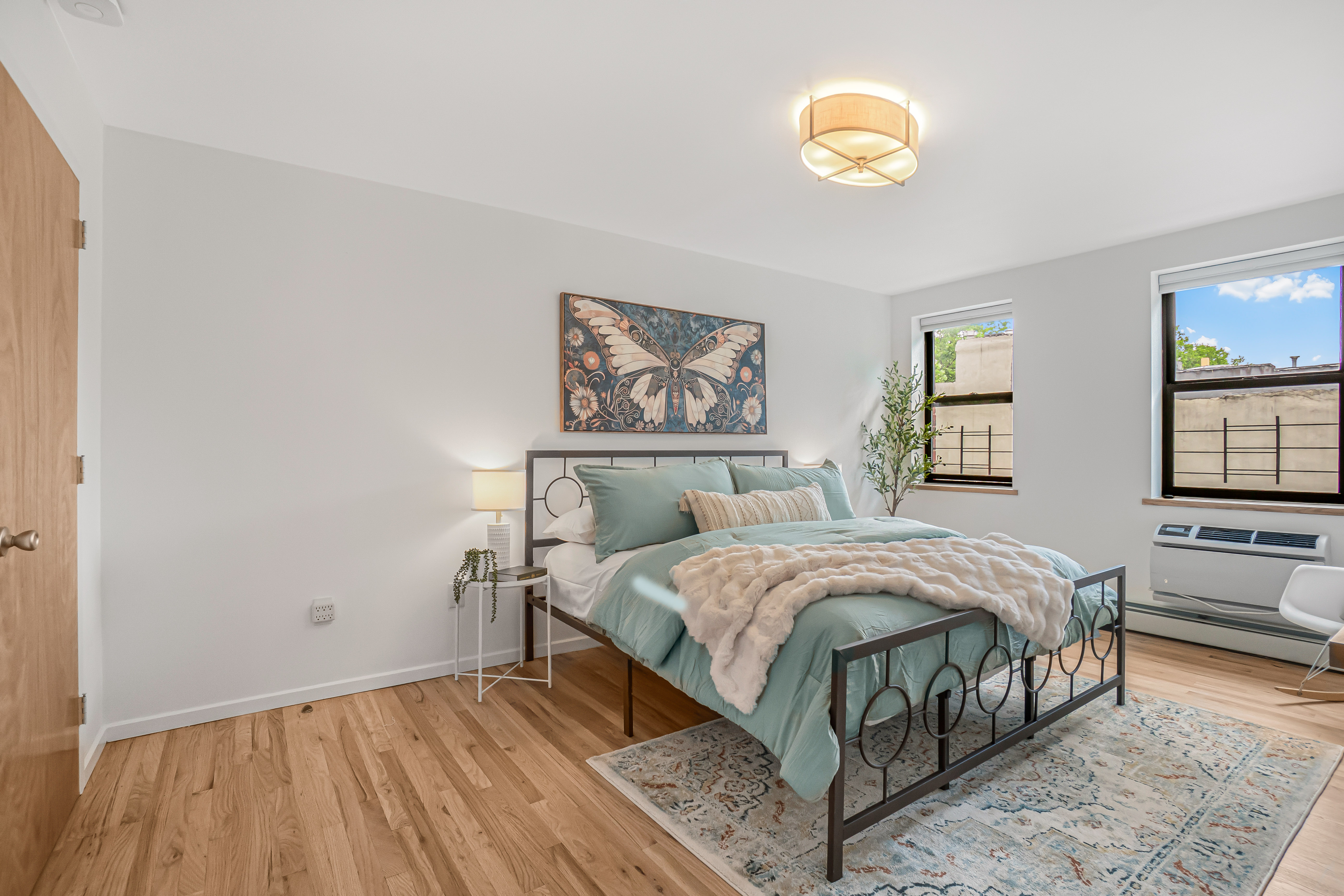 7 Gates Avenue, Unit H Brooklyn, NY 11238 - Photo 13 of 20 a bedroom with a bed and a painting on the wall