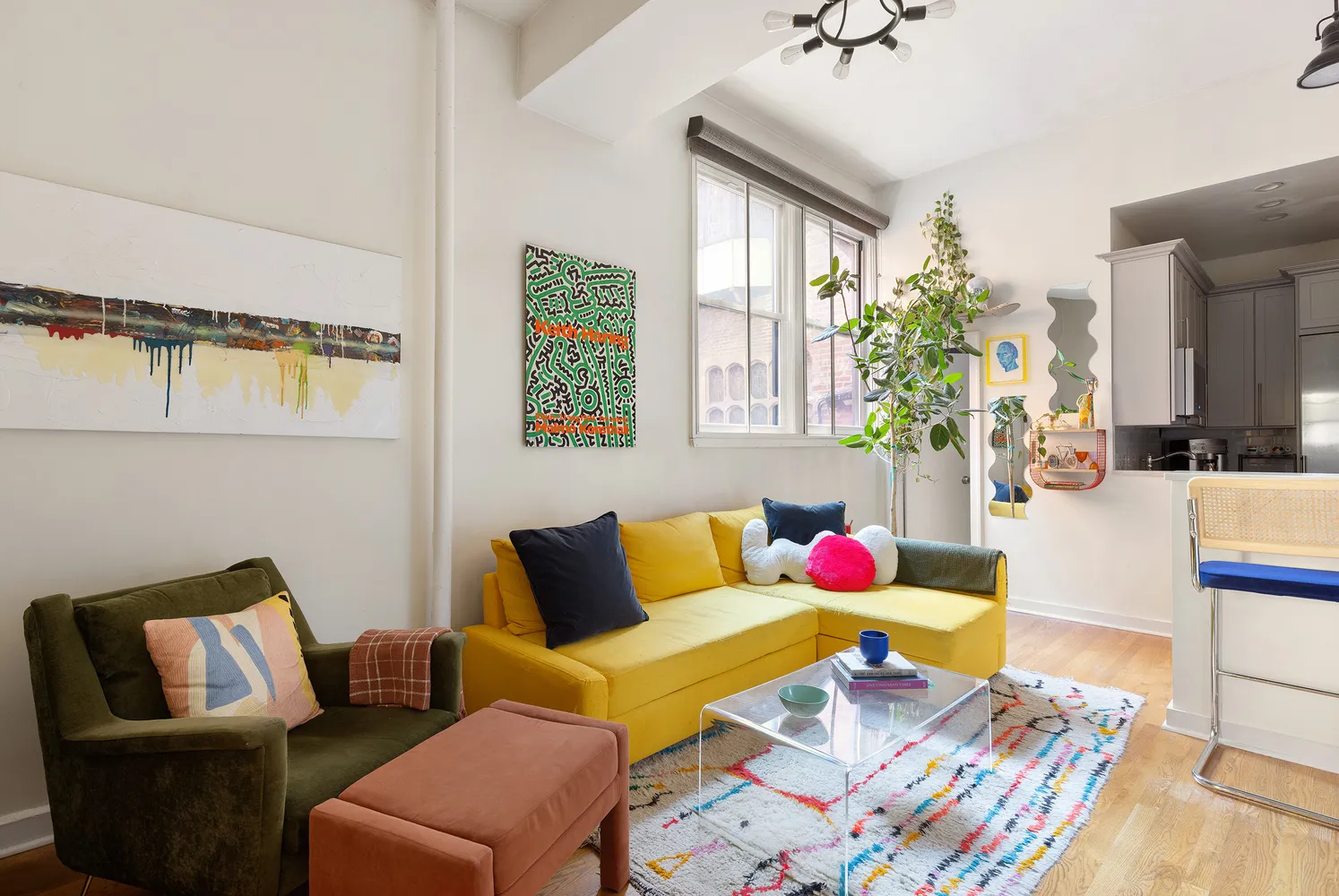 a living room with furniture wooden floor and painting on the wall