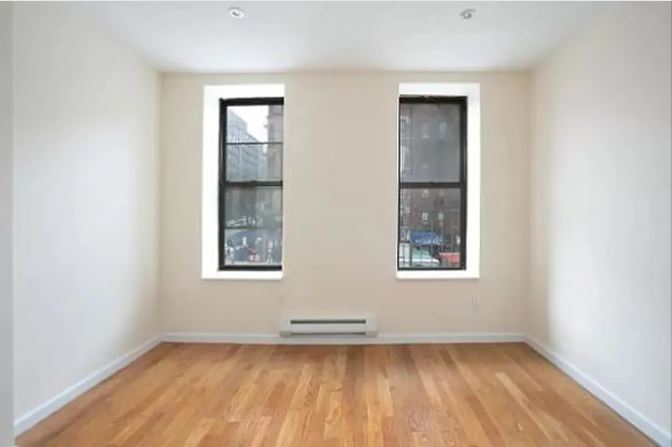 943 Columbus Avenue, Unit 2C Manhattan, NY 10025 - Photo 3 of 5 an empty room with a window
