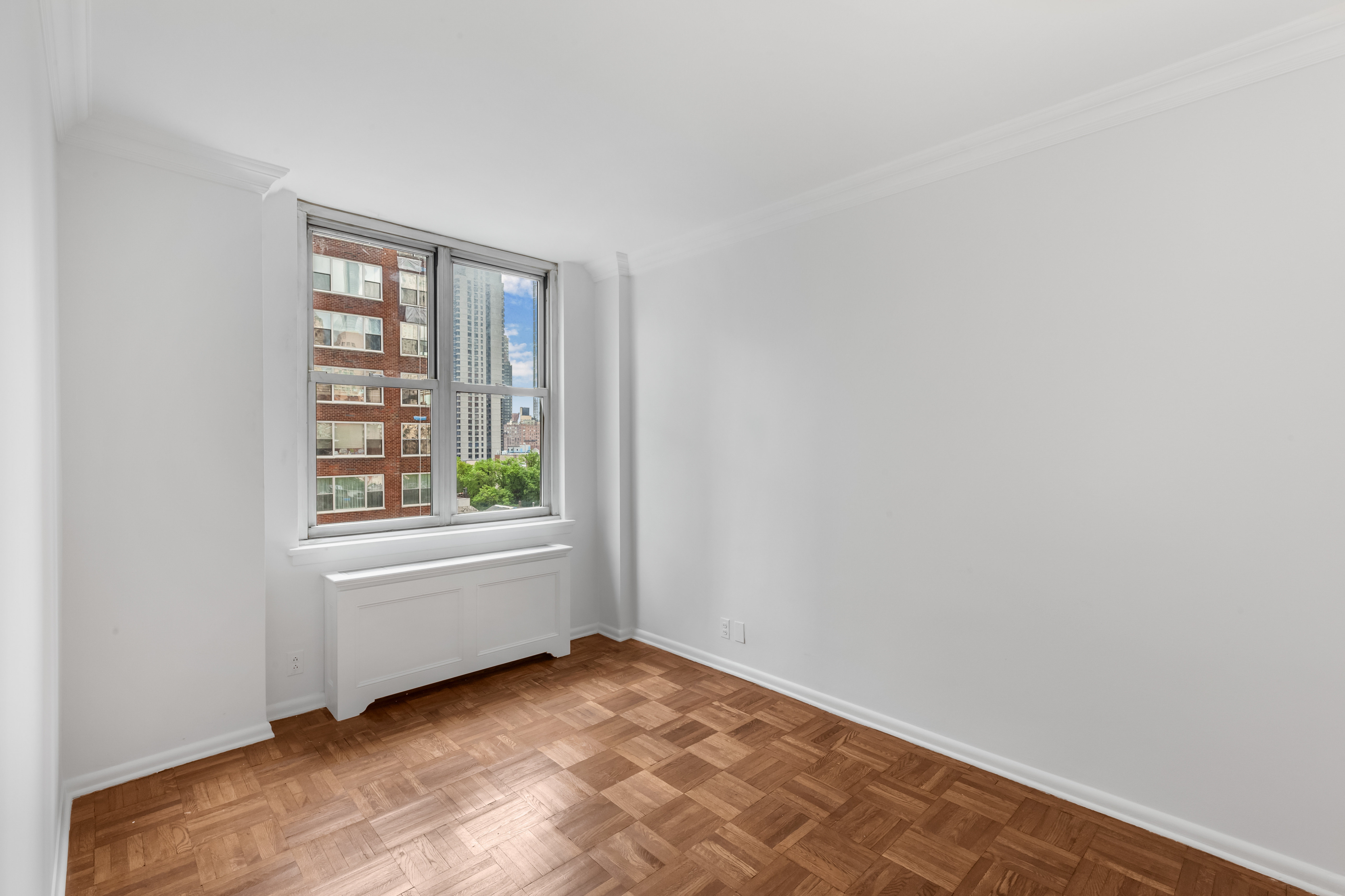 175 East 62nd Street, Unit 10B Manhattan, NY 10065 - Photo 11 of 12 an empty room with windows