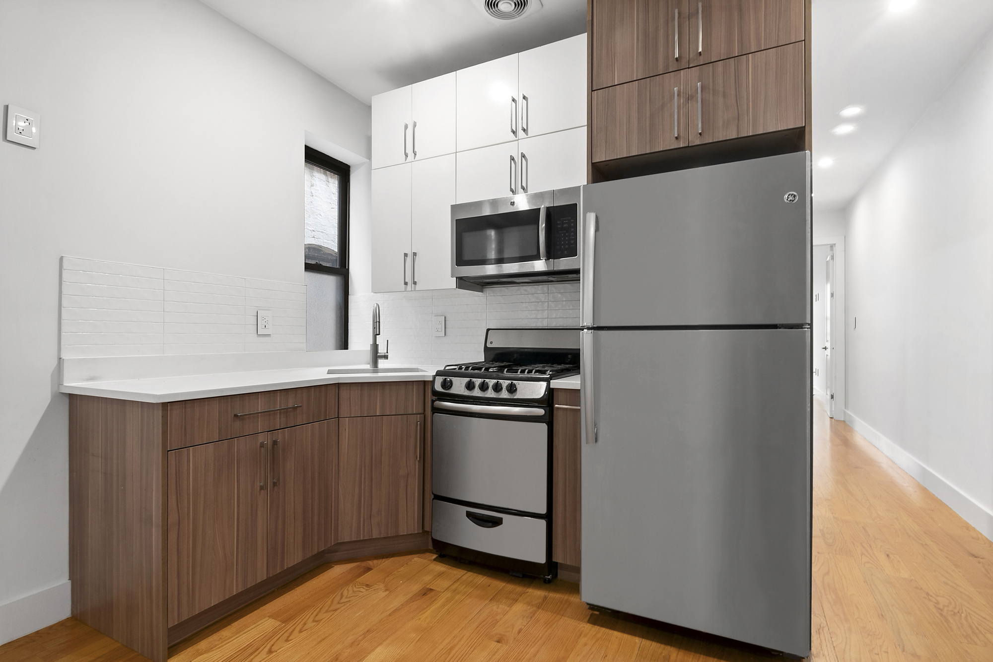 211 8th Avenue, Unit 3B Brooklyn, NY 11215 - Photo 4 of 13 a kitchen with stainless steel appliances a refrigerator sink and microwave