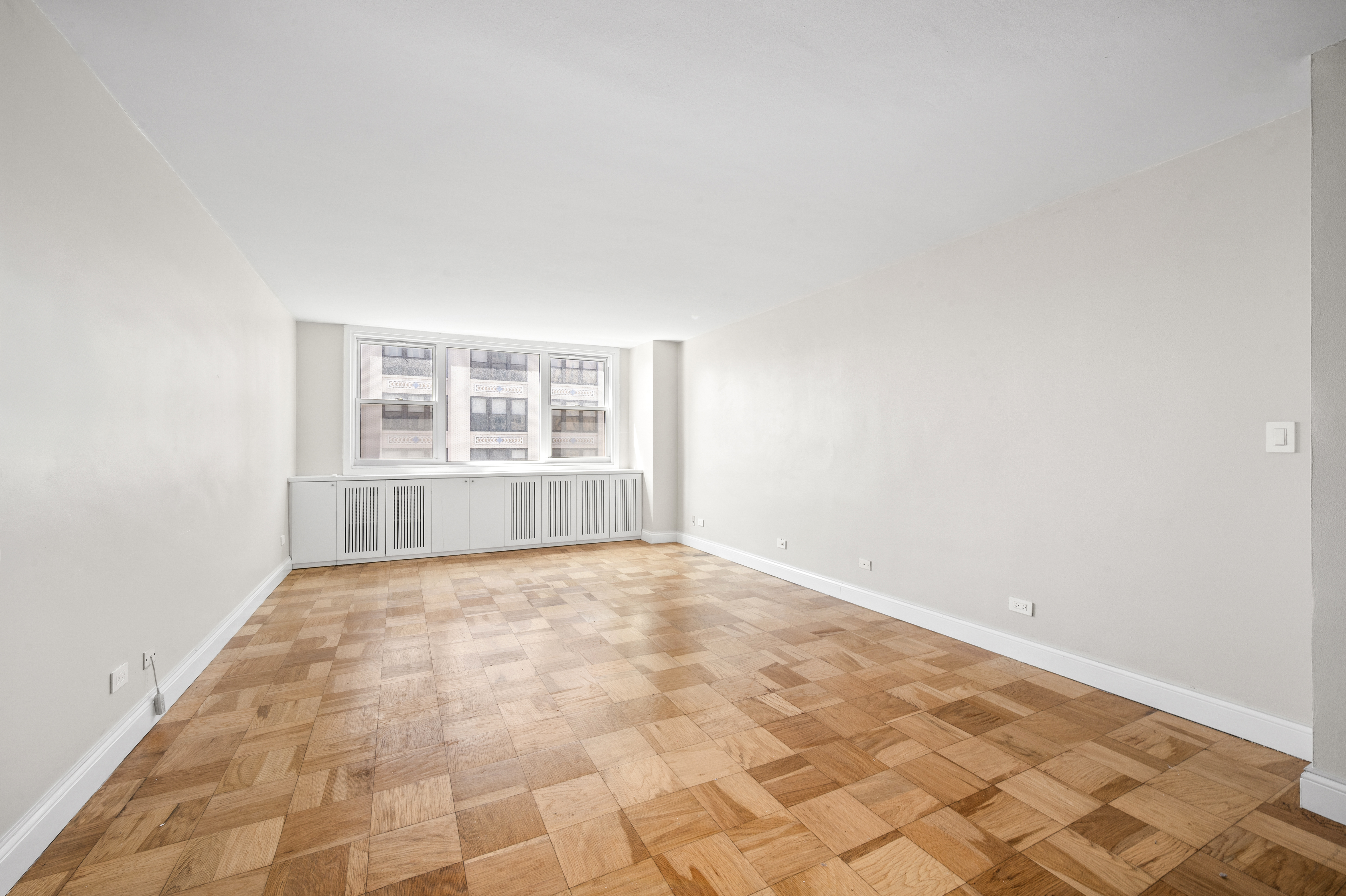 77 7th Avenue, Unit 10N Manhattan, NY 10011 - Photo 2 of 13 an empty room with windows