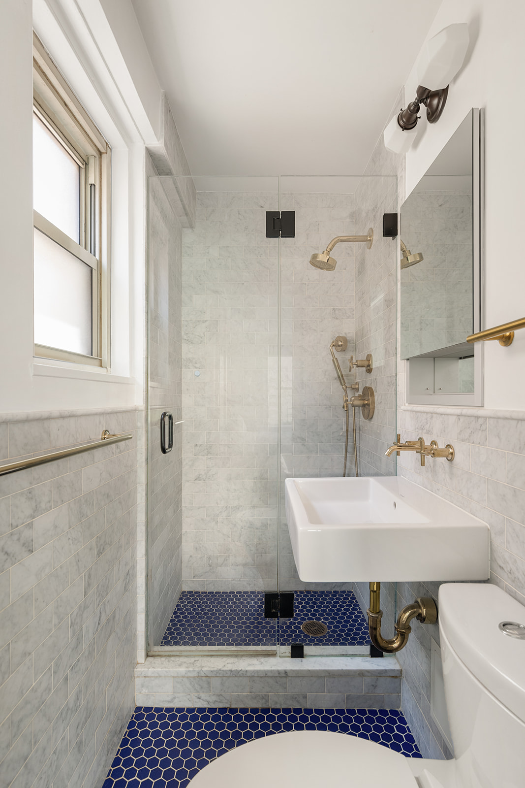 400 East 85th Street, Unit 4L Manhattan, NY 10028 - Photo 5 of 12 a bathroom with a sink a toilet and shower