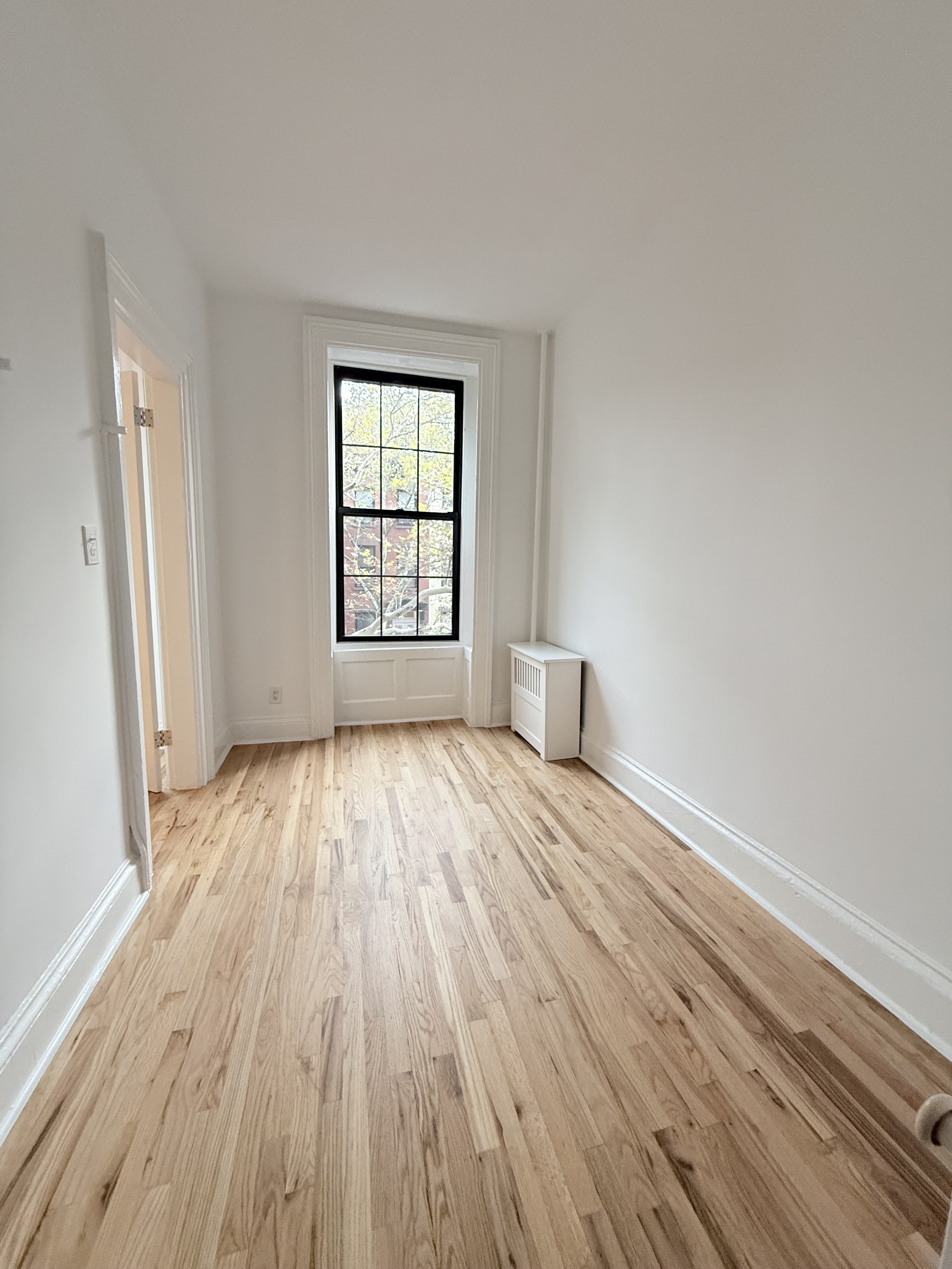 141 Summit Street, Unit 3 Brooklyn, NY 11231 - Photo 16 of 17 a view of empty room with wooden floor and fan