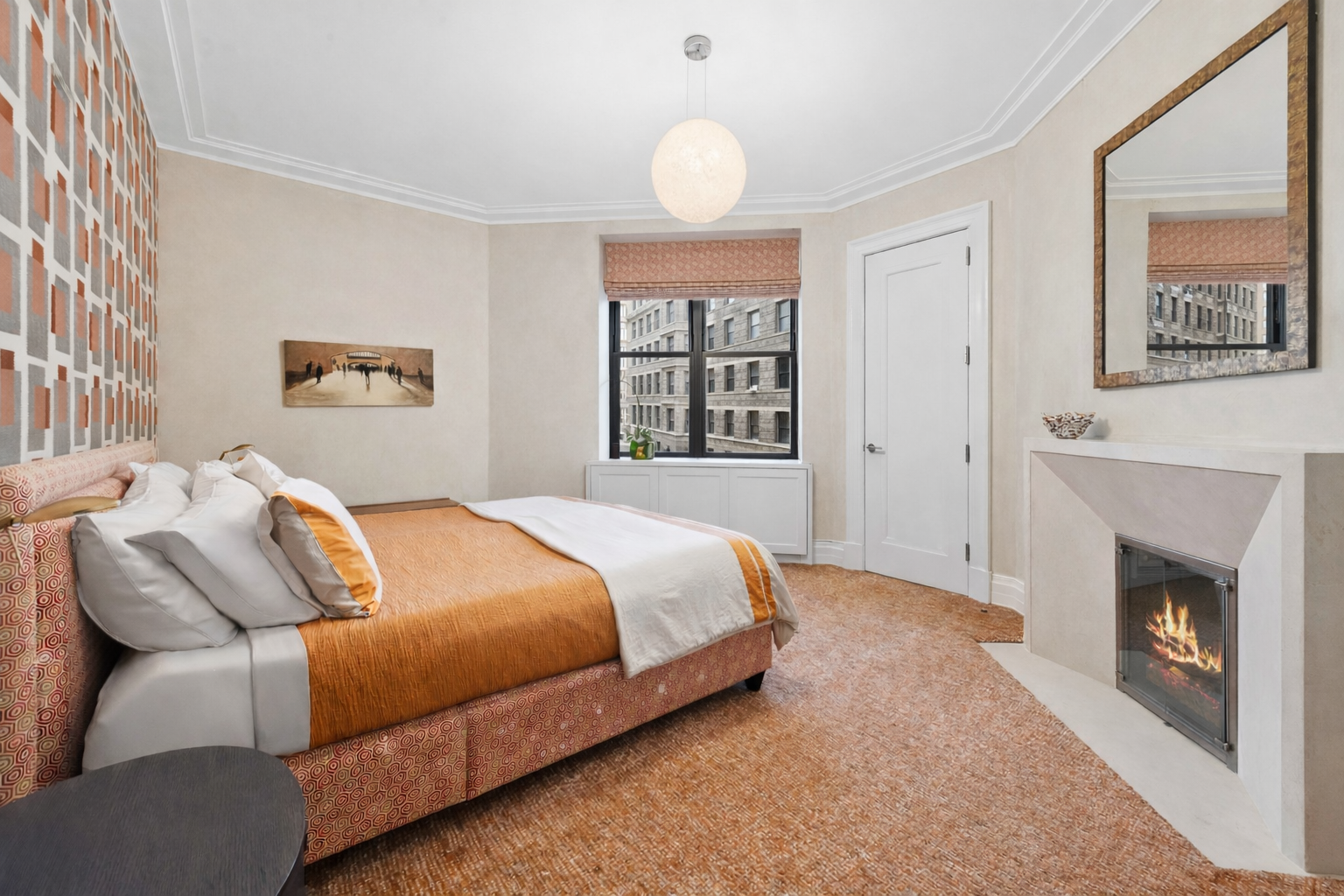 235 West 75th Street, Unit 507 Manhattan, NY 10023 - Photo 6 of 14 a bedroom with a large bed and a fireplace