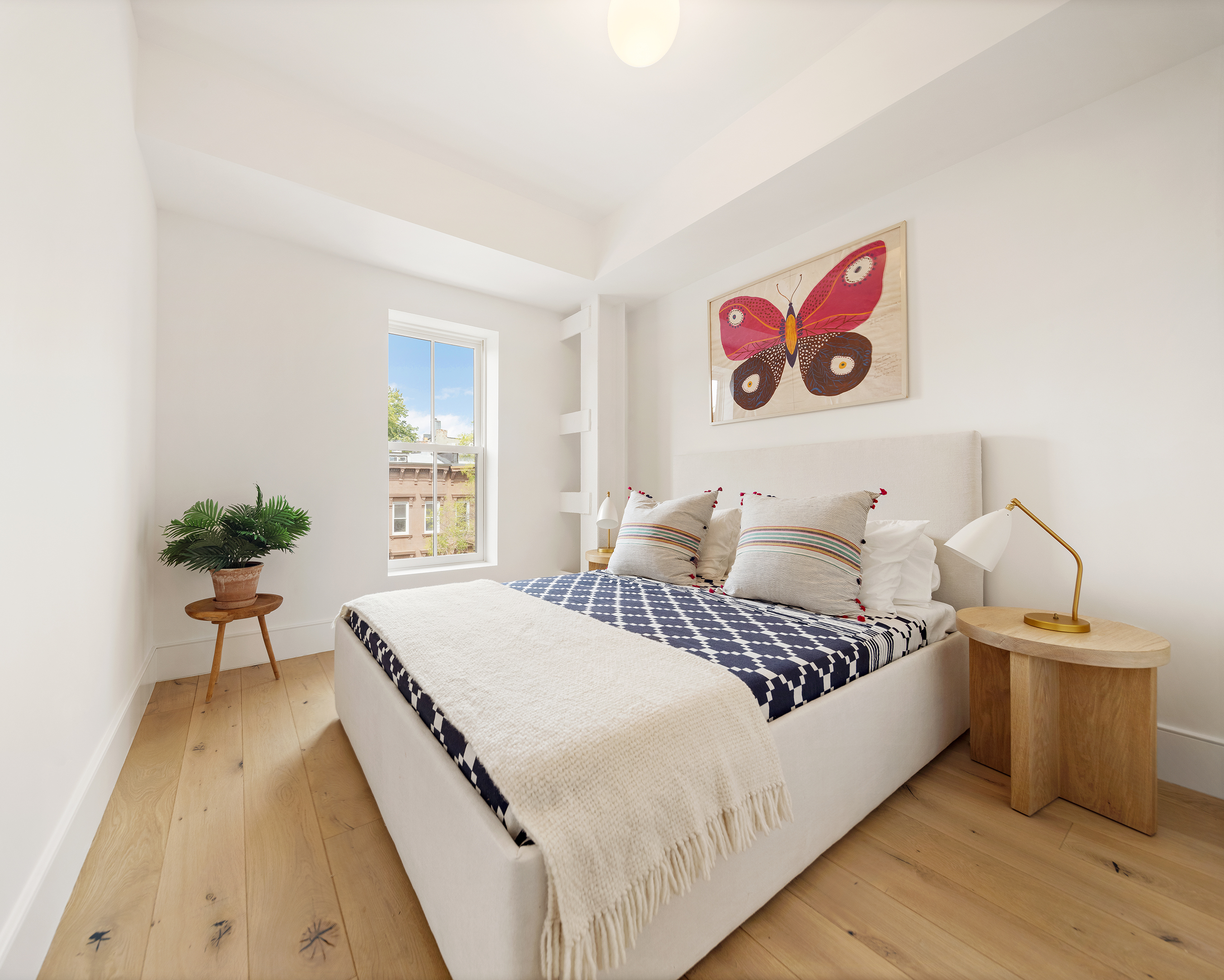 524 Halsey Street, Unit TH1 Brooklyn, NY 11233 - Photo 9 of 17 a bedroom with a bed and a potted plant