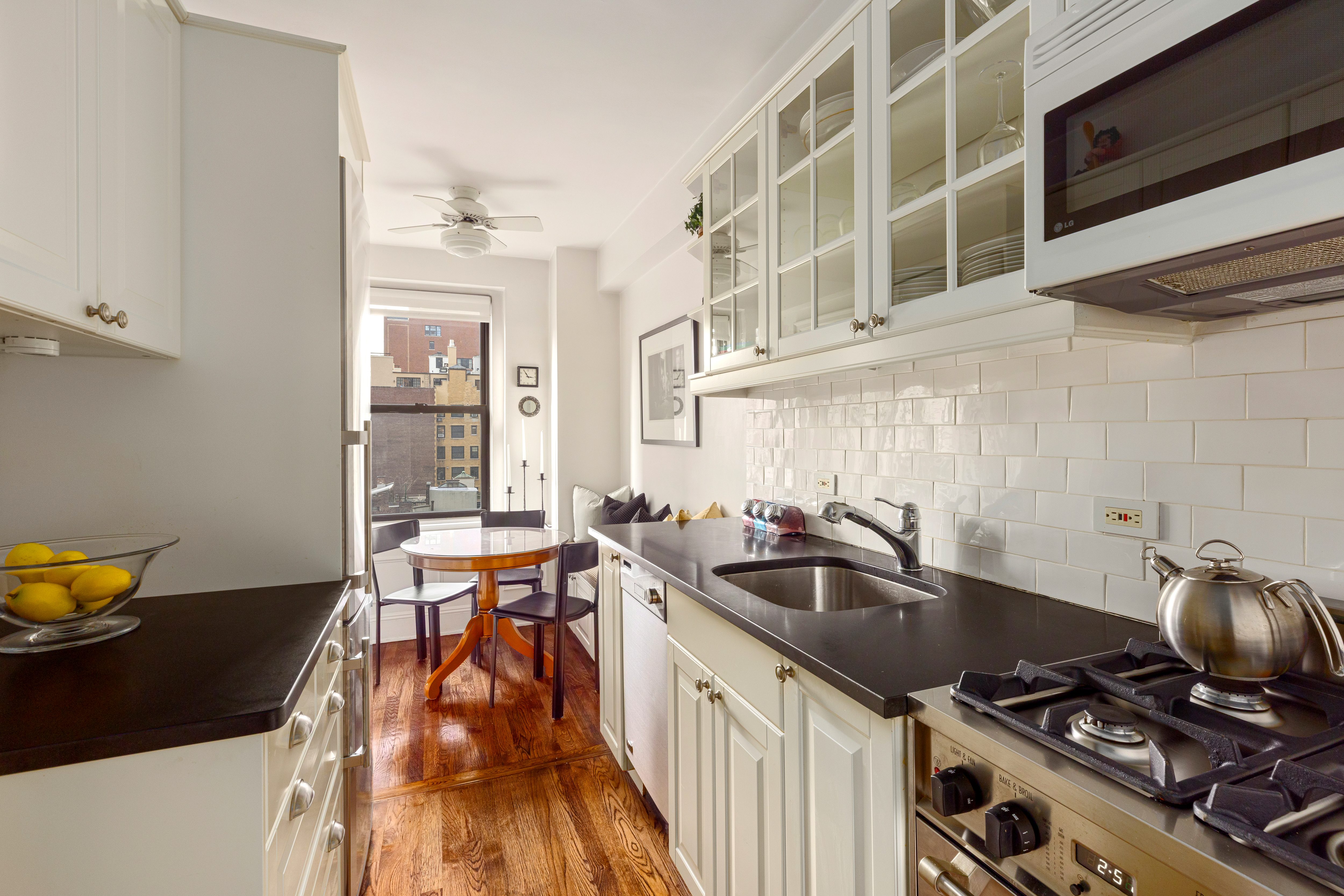 205 East 78th Street, Unit 9F Manhattan, NY 10075 - Photo 5 of 11 a kitchen with a sink appliances and cabinets
