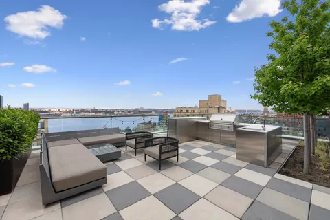 a living room with patio furniture and a potted plant