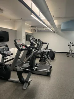 a room with gym equipment and a flat screen tv