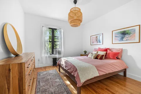 a bedroom with double bed and a window