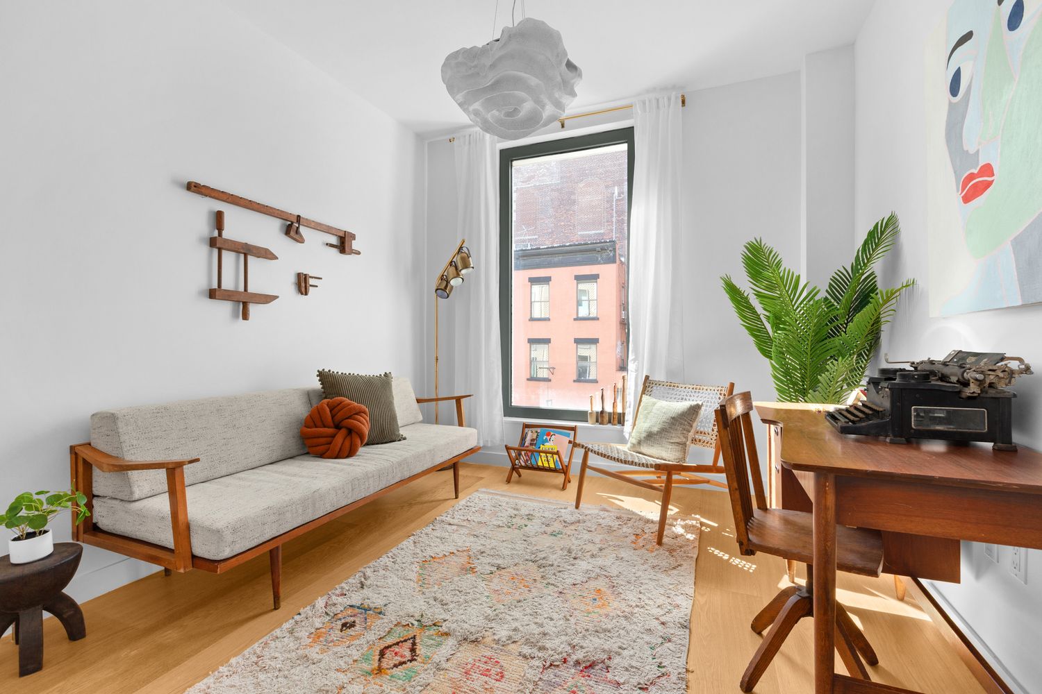 a living room with furniture and a potted plant