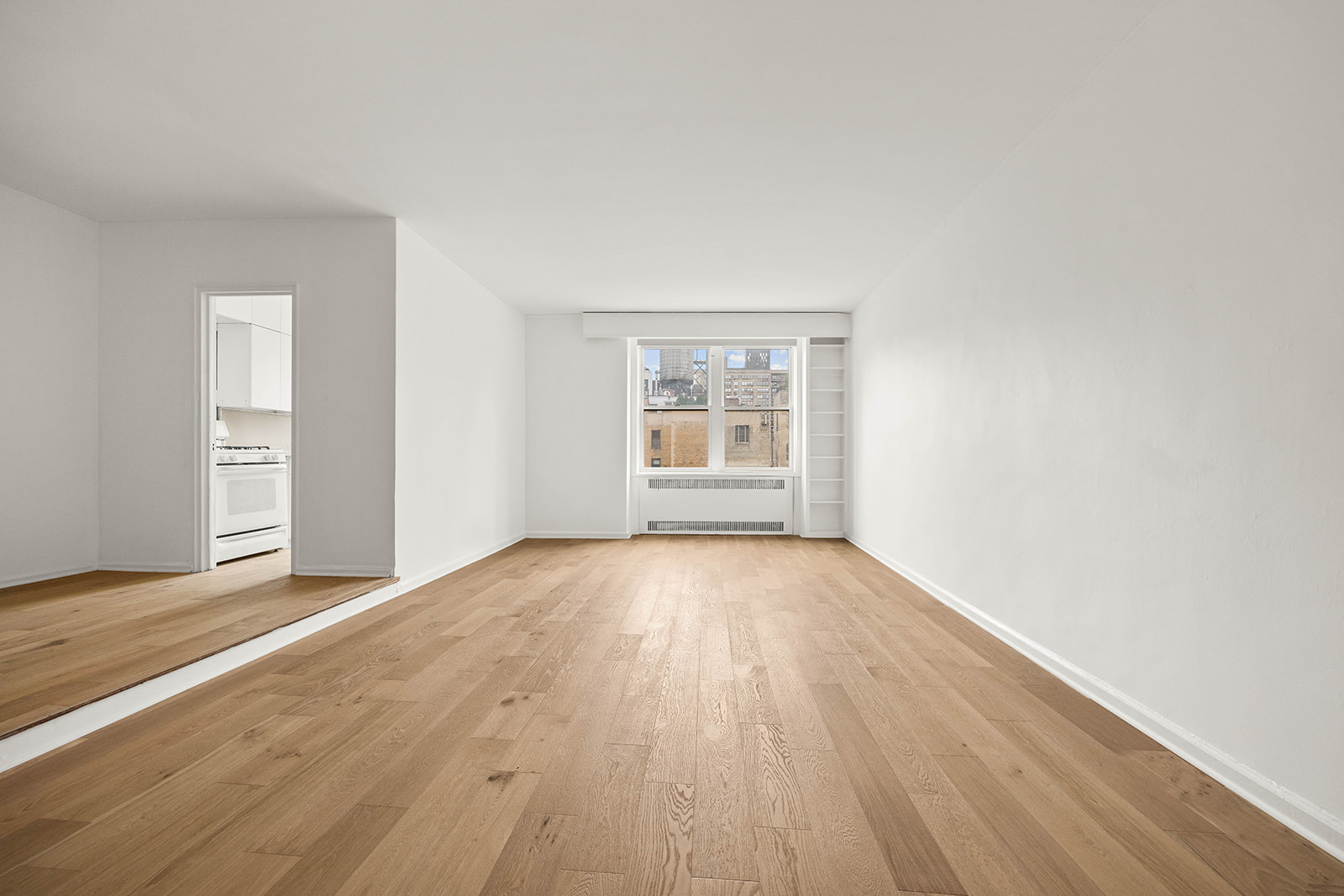 263 West End Avenue, Unit 13F Manhattan, NY 10023 - Photo 2 of 22 an empty room with wooden floor and windows