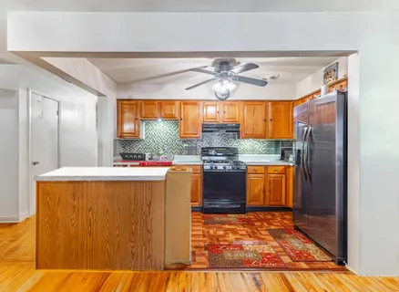 a kitchen with stainless steel appliances granite countertop a sink and a refrigerator