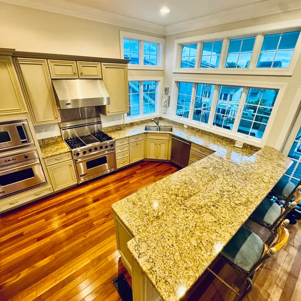 a view of a kitchen with wooden floor and a sink