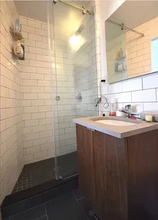 a bathroom with a sink a shower and a mirror