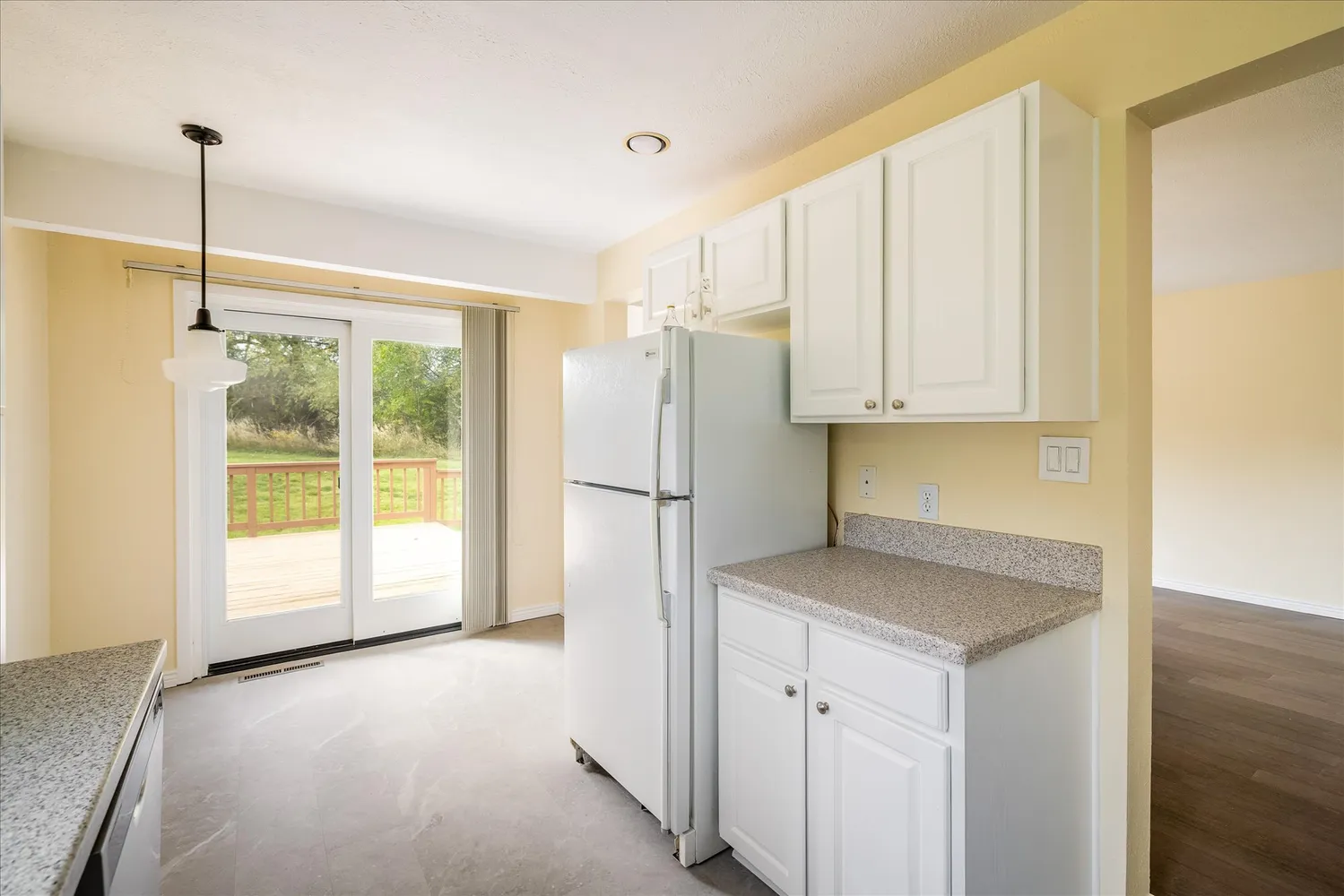 a view of a kitchen cabinets and a refrigerator