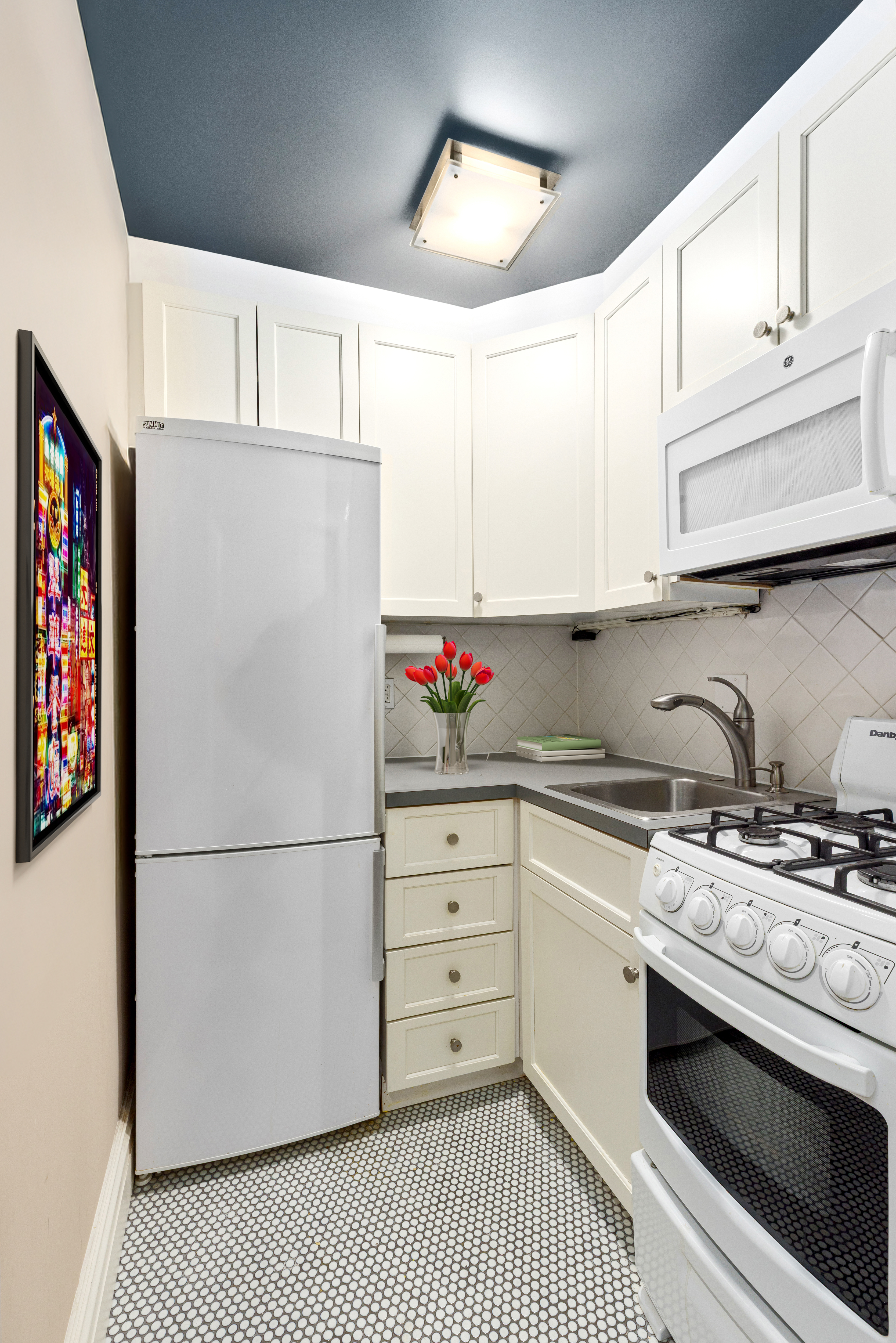235 West 102nd Street, Unit 3B Manhattan, NY 10025 - Photo 5 of 20 a white refrigerator freezer sitting inside of a kitchen