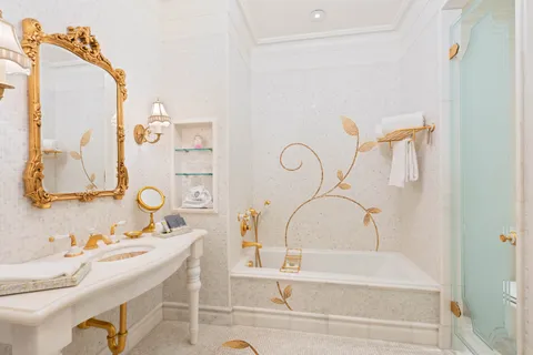 a bathroom with a tub sink and mirror
