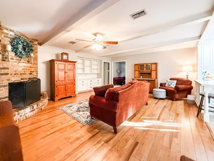 a living room with furniture fireplace and a flat screen tv