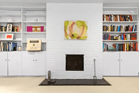 a living room with fish tank and a bookshelf