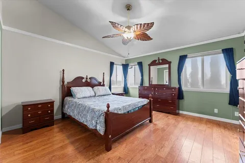 a spacious bedroom with a bed and a dresser