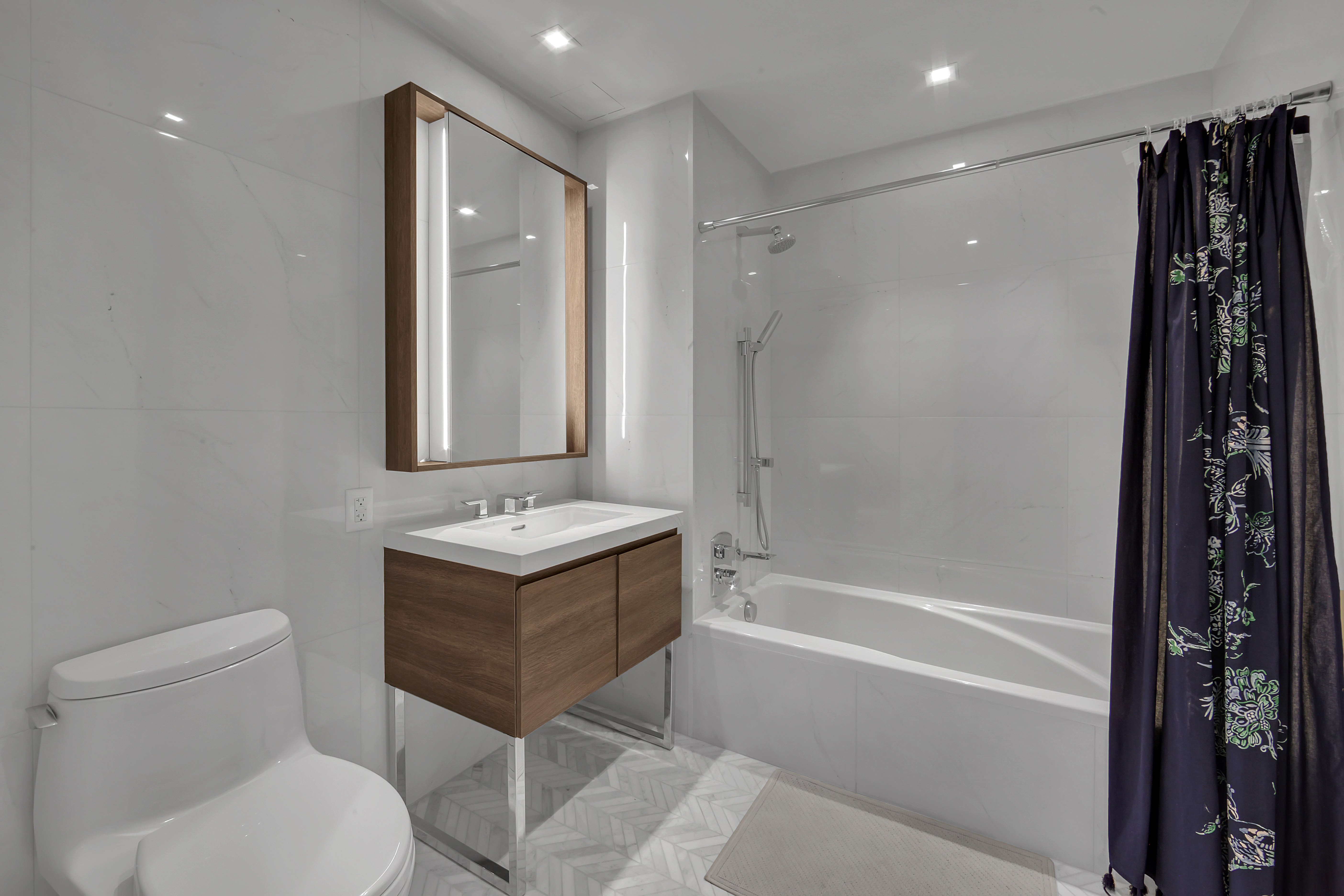 505-513 West 43rd Street, Unit 3M Manhattan, NY 10036 - Photo 11 of 20 a bathroom with a sink toilet and shower