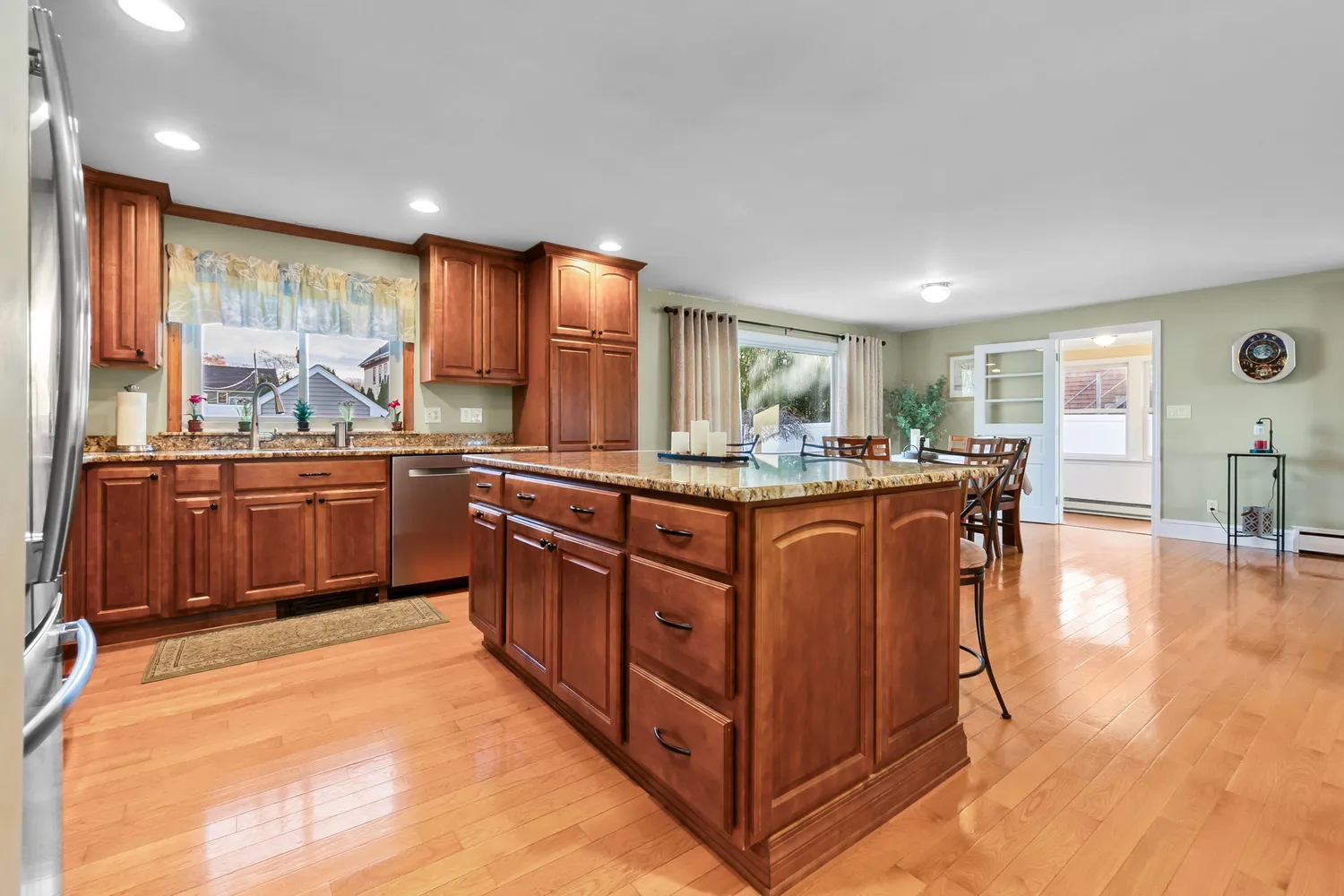 a kitchen with stainless steel appliances granite countertop sink stove and wooden cabinets