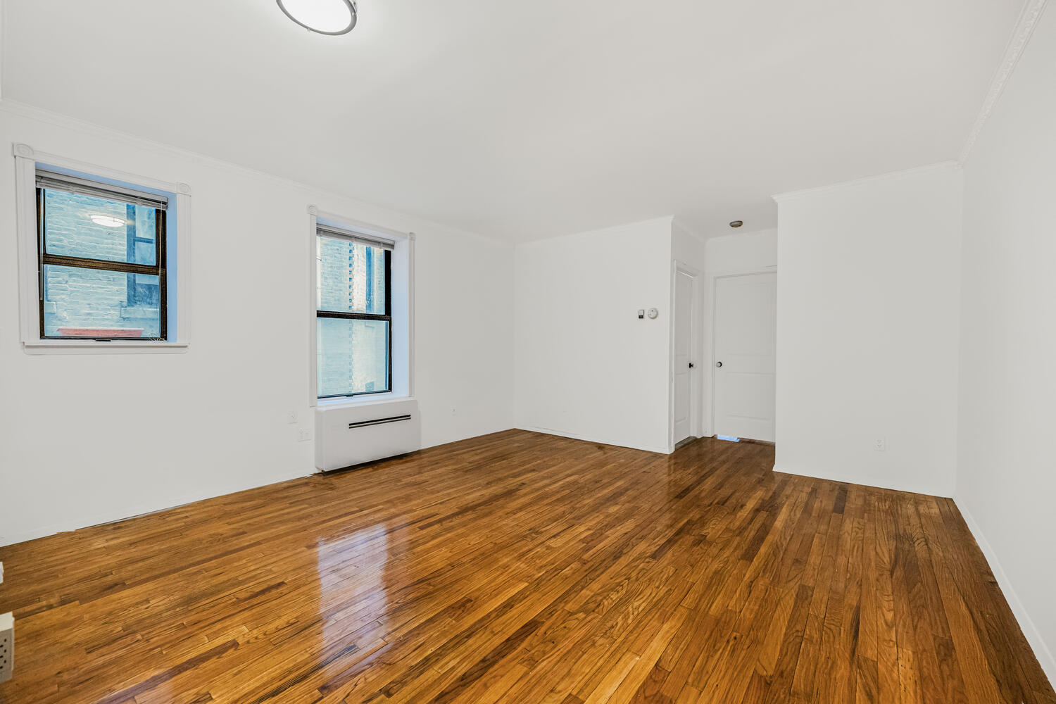 4 West 109th Street, Unit 4F Manhattan, NY 10025 - Photo 2 of 16 a view of empty room with wooden floor and fan