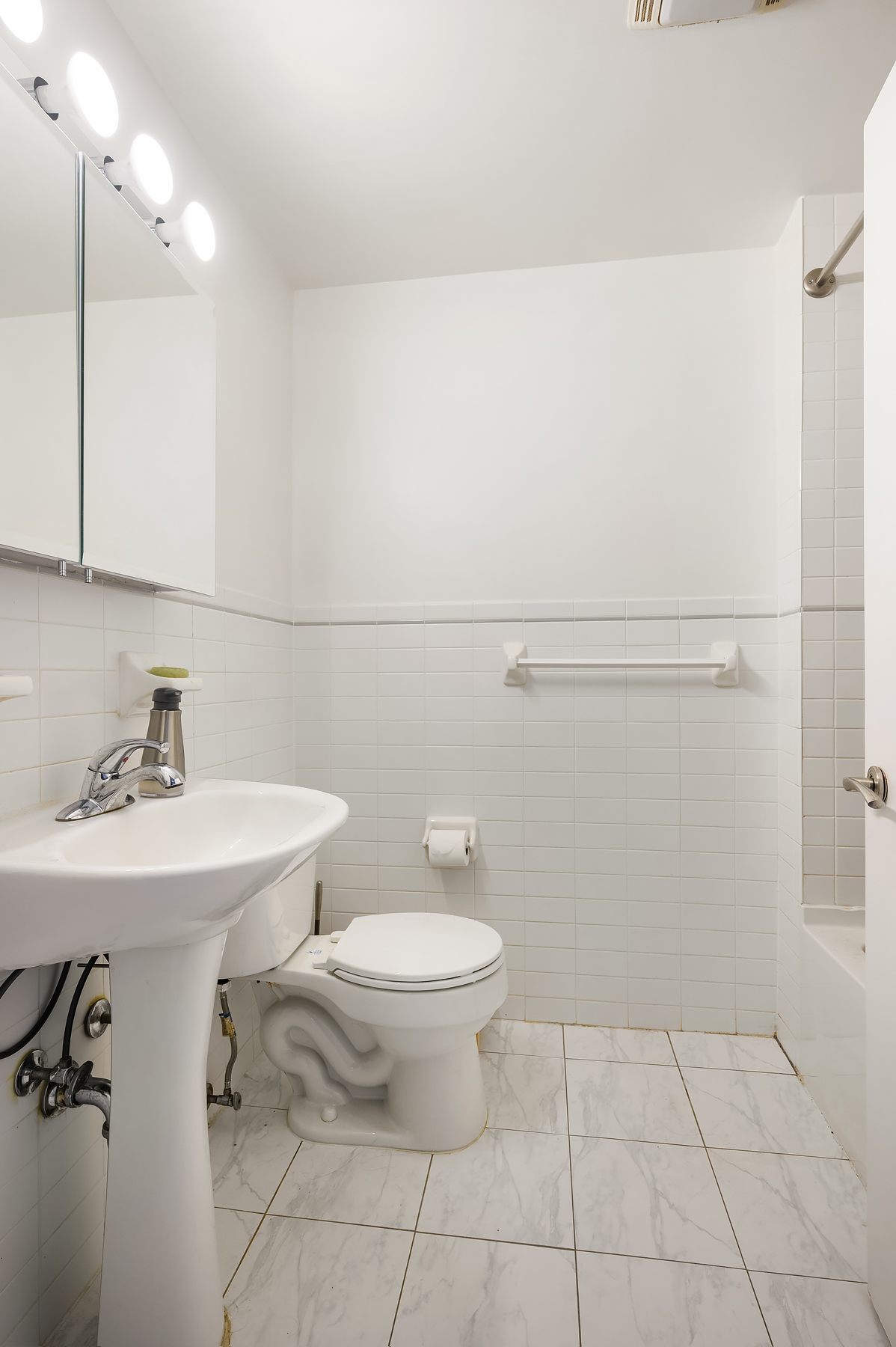 29 West 138th Street, Unit 5A Manhattan, NY 10037 - Photo 5 of 9 a bathroom with a toilet a sink and mirror