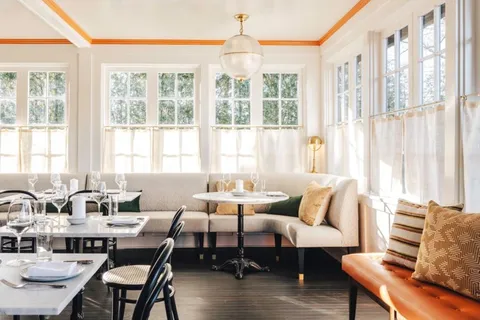 a living room with furniture and large windows