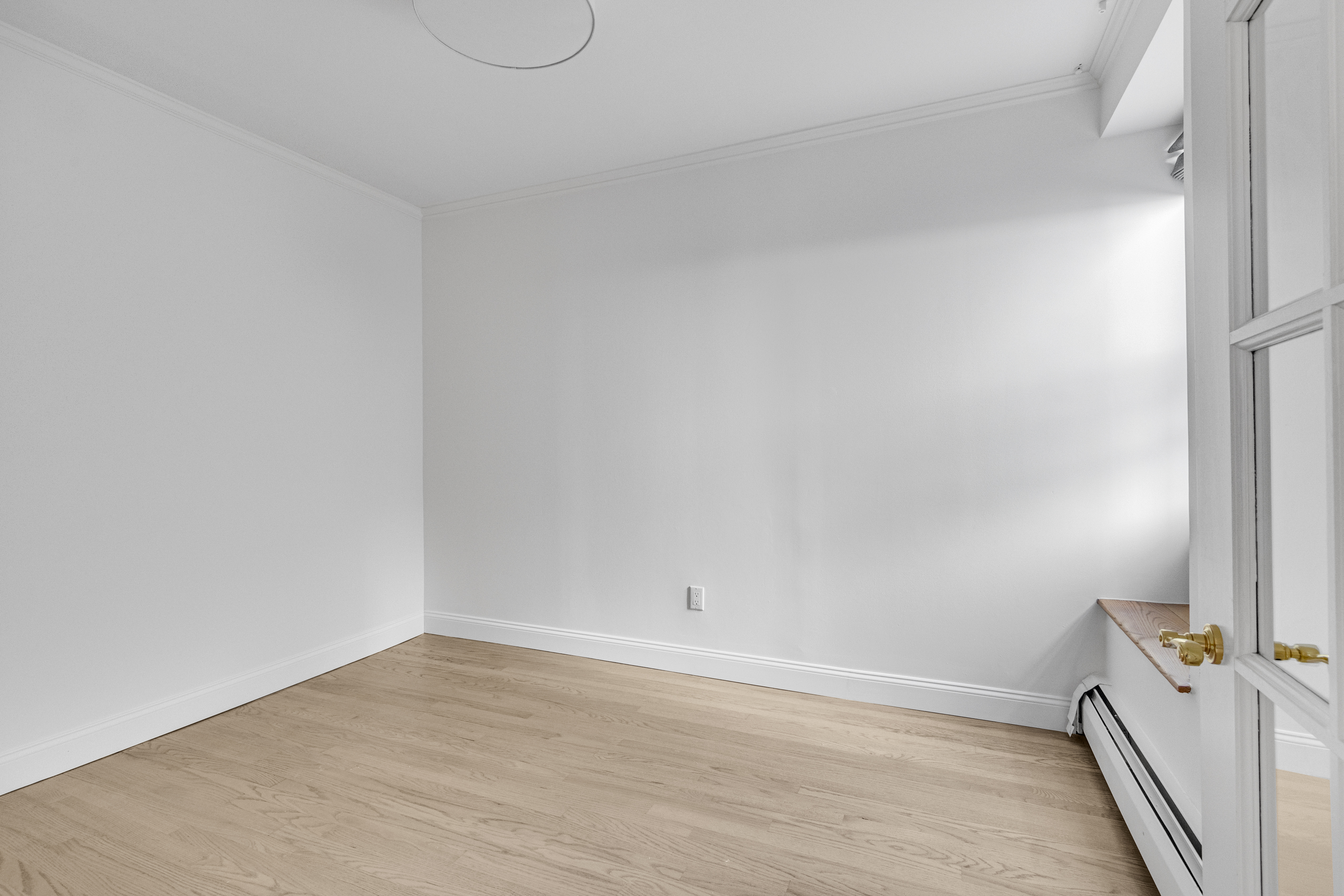 305 West 98th Street, Unit 7CS Manhattan, NY 10025 - Photo 13 of 18 a view of a room with wooden floor and white walls