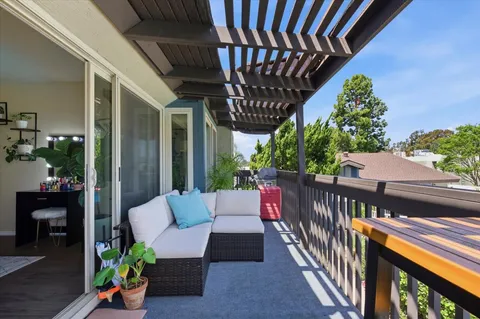 a view of a porch with furniture and wooden floor